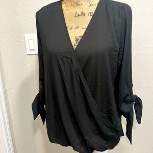 Beautiful black blouse. V neck with toe side sleeves